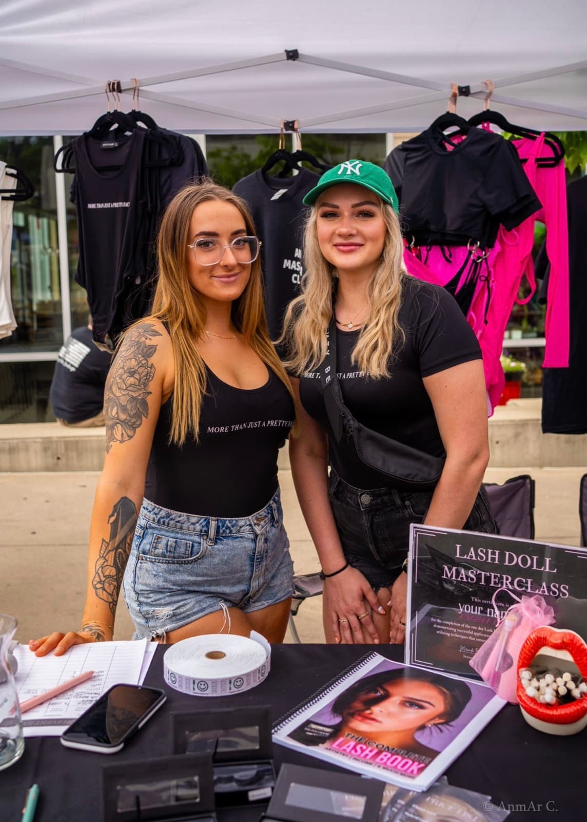 Miranda and a teammate at their Lash Doll Masterclass pop-up market stand