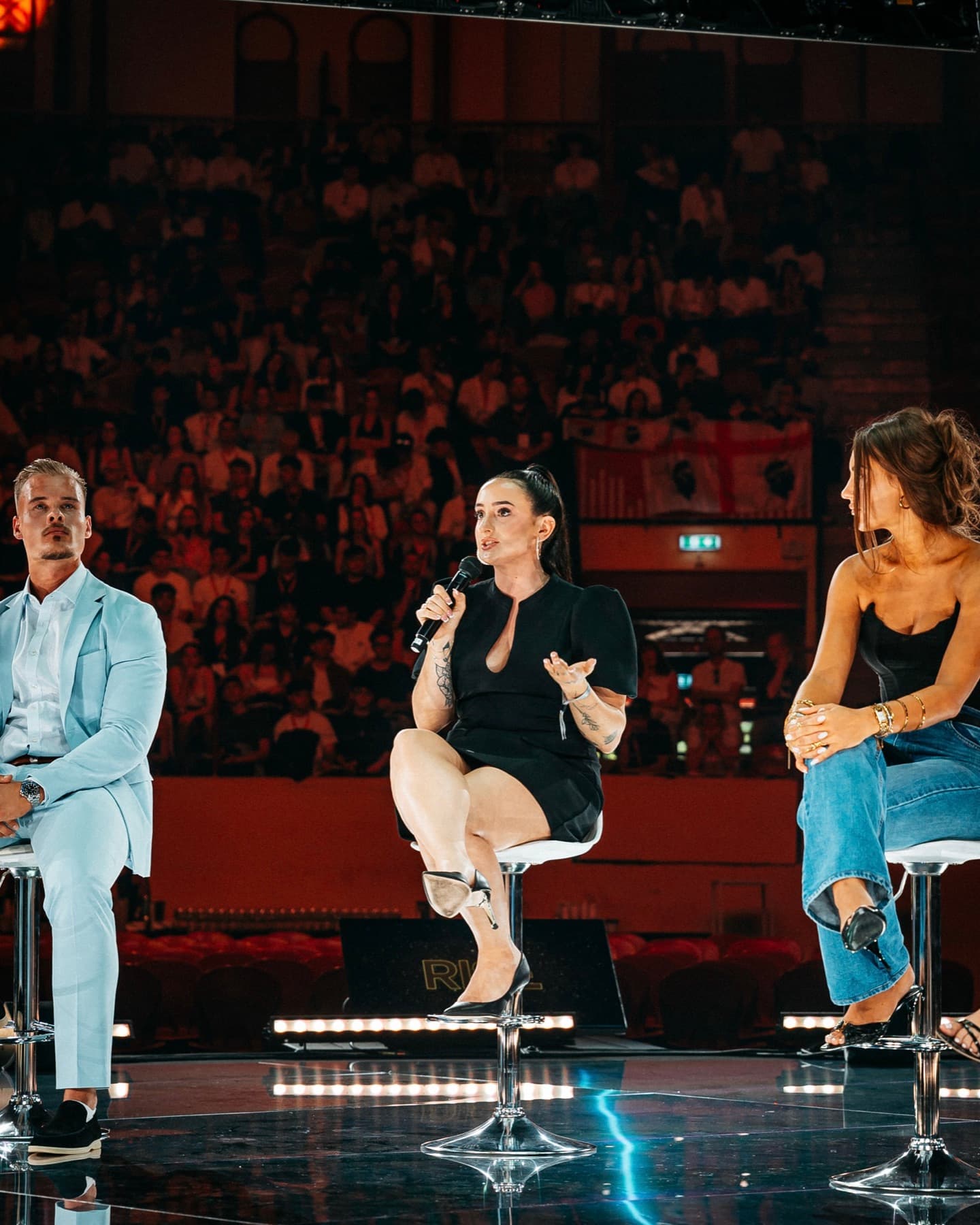 Miranda speaking on a panel on stage, coaching creators on UGC and business building